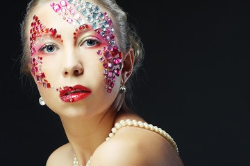 Closeup portrait of woman with artistic make-up.