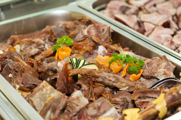 Lamb meat in a heated tray