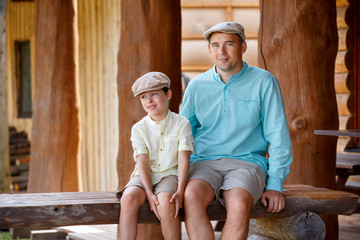 Happy father with son talking and having rest outdoors in city