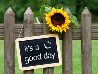 It's a good day - chalkboard with sunflower in the summer garden