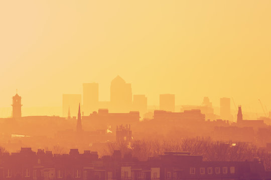 London Cityscape at Sunrise with early morning mist from Hampstead Heath looking towards Canary Wharf, England, UK