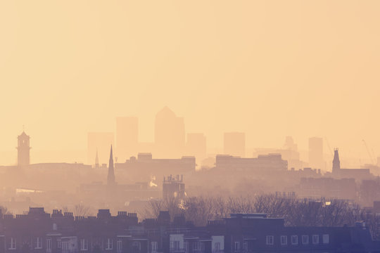 London Cityscape at Sunrise with early morning mist from Hampstead Heath looking towards Canary Wharf, England, UK
