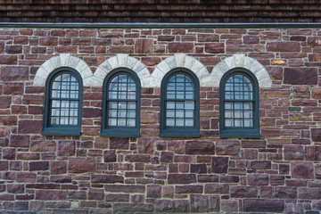 arched windows on the stone wall of a historic Farm Barn at Shelburne Farms, National Historic Site

