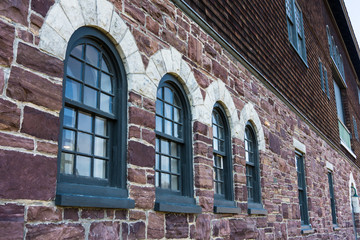 arched windows on the stone wall of a historic Farm Barn at Shelburne Farms, Vermont
