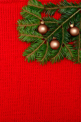 Fir branch with decoration on knitted background