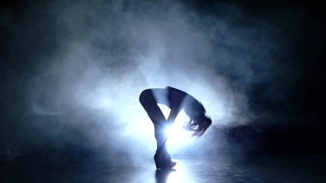 beautiful striptease dancer posing in studio background. Slow motion. smoke