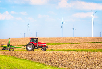 USA  farmer farming with tractor on wind farm Danville Illinois