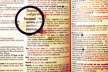 Fototapeta premium Dictionary definition of the word focused and reading glass