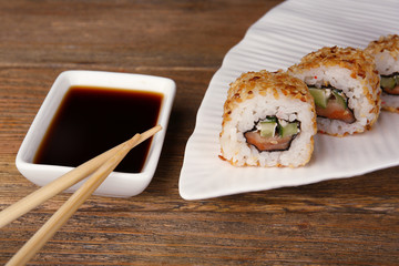 Rolls with sauce and sticks on wooden table close up