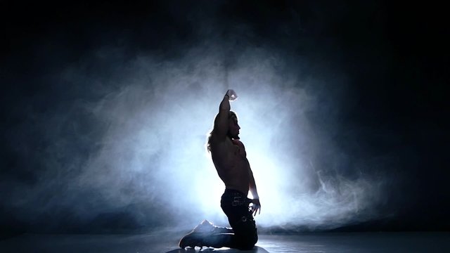 Night club dancers, young man dancer on the floor. Slow motion, smoke