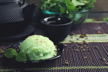 Homemade Green tea ice-cream on bamboo mat, on wooden background