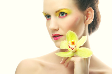 Obraz na płótnie Canvas young woman with bright make up holding orchid