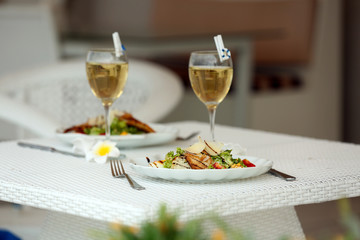 Tasty salad on white served table, outdoors