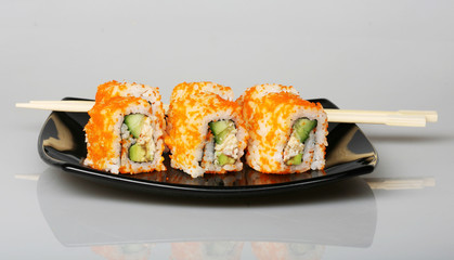 japanese  rolls on black plate.
