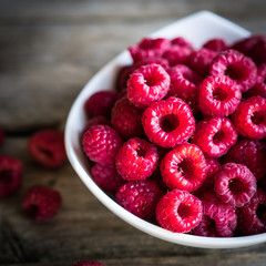 Fresh raspberries on rustic wooden background