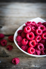 Fresh raspberries on rustic wooden background