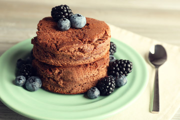 Cake with berries on wooden table