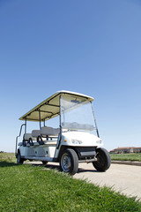 Naklejka premium White golf carts at the green golf course