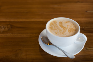 Hot art Latte Coffee in a cup on wooden table