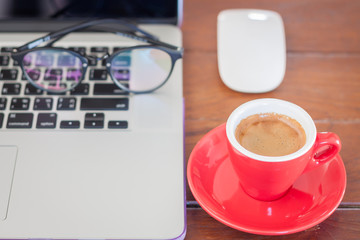 Red coffee cup on work station