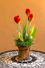 Vase of tulips on table./ Beautiful spring tulips in vase on table for Easter or Mother's Day with copy space.

