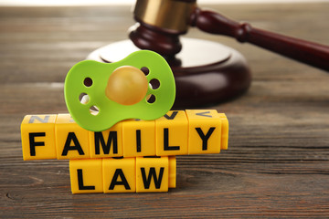 A gavel, a dummy and blocks regarding child-custody and divorce concept