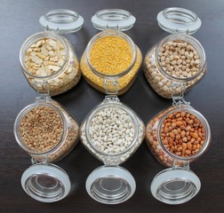 Grains and beans in glass jars in the kitchen