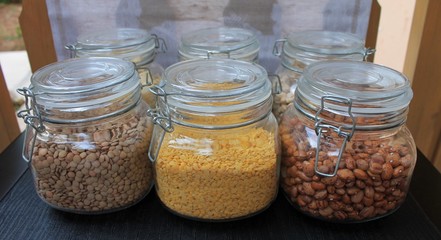 Grains and beans in glass jars in the kitchen