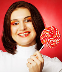 Portrait of young woman with lollipop