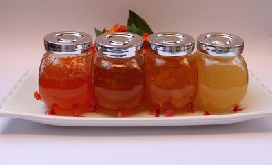 Fototapeta na wymiar Jam of quince, peaches, apricots and honey in glass jars