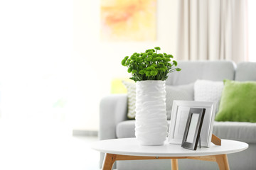 Beautiful green chrysanthemums in vase on table in room