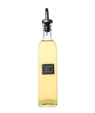 Vegetable cooking oil in an oil dispenser bottle over white background