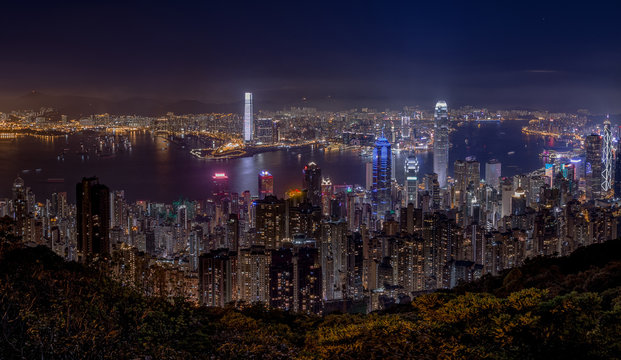 Panorama Image Of Hong Kong And Kowloon Cityscape At Night From Peak