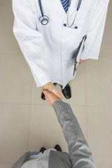 Doctor and businessman shaking hands