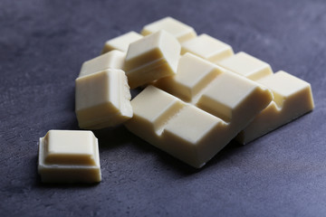 White chocolate pieces on gray background