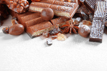 Chocolate sweets with powder on wooden background