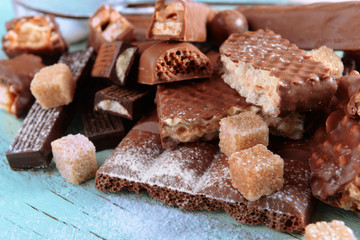 Chocolate sweets with powder on wooden background
