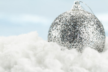 beautiful Christmas ball in snow on blue background