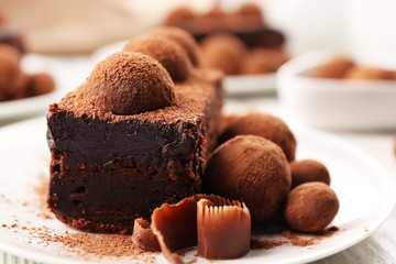 Slices of chocolate cake with a truffle on plate closeup