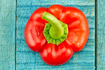 fresh red pepper on a blue wooden background. Diet, vegetarianism, healthy food