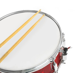 Red drum with drum sticks isolated on white background, close up