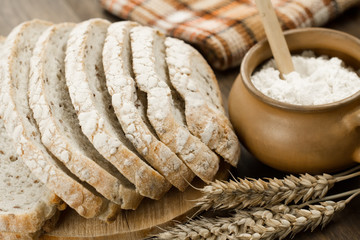 Loaf freshly baked traditional bread on  wooden table