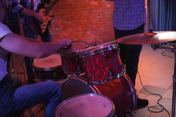 Musicians playing musical instruments on brick wall background