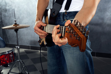 Fototapeta na wymiar Young man paying guitar closeup