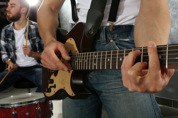 Young man paying guitar closeup