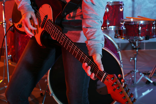 Musician playing guitar closeup