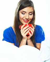 Beautiful woman sitting in bed with closed eyes