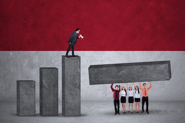 Businesspeople make graph with flag of Indonesia