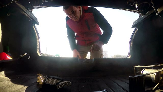 the man opens the trunk of the car takes the keys for repair HD
