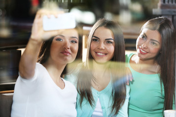 Best friends together takes selfie in the mirror